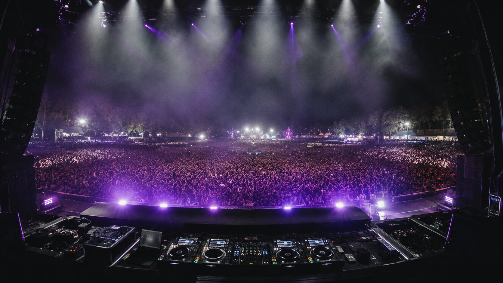 Festival crowd under purple stage lighting
